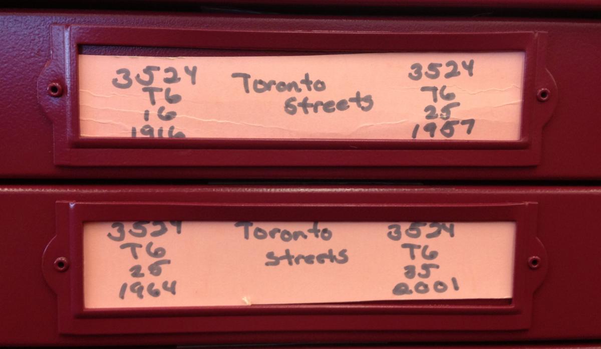 Photo showing labels of two adjacent map drawers.